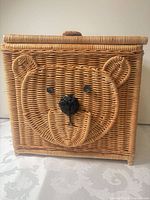 Front view of square wicker basket showing bear face design