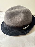 Full view of gray wool fedora with black brim and band