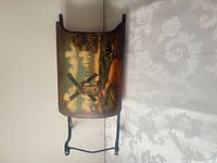 Overall view of magazine rack showing hand-painted windmill scene and metal frame