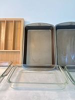 front view of two loaf pans, three glass dishes and bamboo organizer