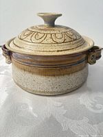 Casserole with lid on, showing glaze and side handles