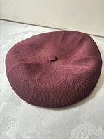 Top view of burgundy knit beret