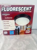 Front of box showing product name, size, finish and image of fixture