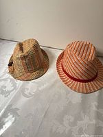 Both straw fedoras side by side