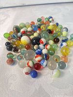Pile of assorted glass marbles in varied colors and sizes