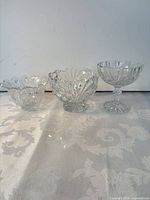 All three clear cut glass pedestal bowls side by side
