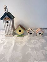 Group shot of all four birdhouses showing relative sizes and styles