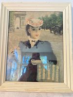 Front view of signed print under glass in cream frame