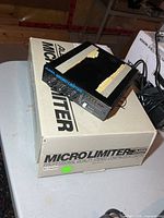Front view of Alesis Micro Limiter on its box