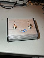 Top view showing two switches, LED indicators and Apex logo