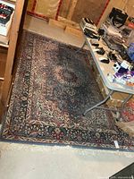Full view of rectangular floral wool rug on basement floor
