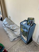 Inflatable bed rolled up, wheeled carry bag, pump box