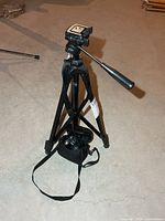 Full view of tripod with camera bag attached