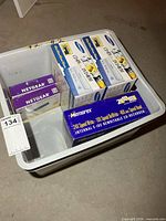 Bin showing multiple boxed computer accessories