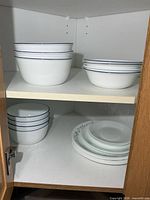 Cabinet view showing stacks of bowls and plates
