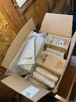 Open box showing pump, boxed pads, loose pad