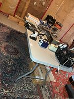 Full view of table with objects on top showing size and colour