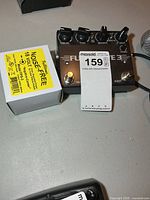 Top view of Full-Drive 3 pedal alongside boxed power cord