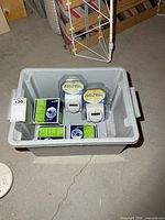 Gray bin containing three Leviton boxes and two packaged digital timers