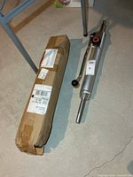 Boxed hydraulic jack beside unboxed unit