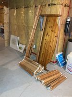 Disassembled pine bed components, extra slats and plywood sheets