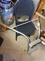 Full view of ladder extension stabilizer showing curved rails, cross brace, steps and orange end caps