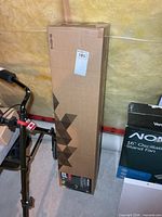 Full view of sealed cardboard box containing the tree