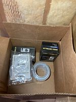 Contents in box showing two speed controller boxes, hygrometer in plastic, foil tape roll