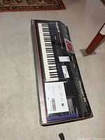 Retail box showing M-Audio Oxygen 61 keyboard with shipping labels attached