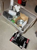 Overview of tote with assorted supplies including damper, funnel, contractor bag pack