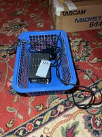 Converter in blue basket with cord visible