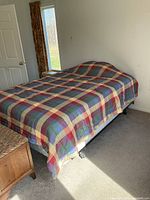 Queen bed fully made showing comforter and frame