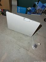 Front view of white radiant panel heater with power cord