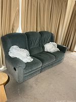 Front view of blue-grey three-seat sofa with two white pillow shams