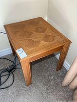 overview of square wooden side table in corner