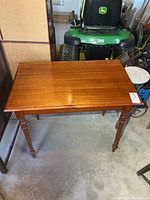 Full view of rectangular solid wood table with turned legs