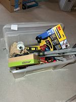 Overview of tote with visible levels, pipe wrench, clamp, 3M item, tote itself