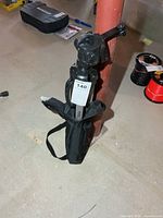 Folded tripod inside black carry bag