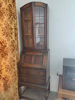 Full view of secretary showing bookcase top, desk, drawers and legs