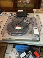 Technics SL-D2 turntable with dust cover and cables on table
