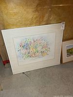 Overall view of framed watercolour painting leaning against wall