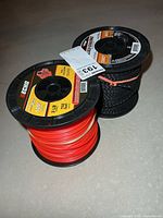 Two large spools, red line front, black line rear