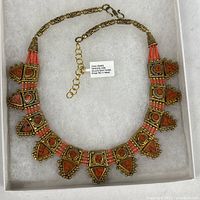Full view of coral and gold-plated brass choker necklace in box