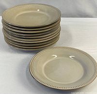 Stack of eleven matching stoneware pasta bowls