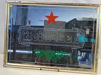 Front view of framed mirror sign showing Heineken graphics and gold frame
