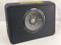 Front view of Kicker CompC subwoofer in enclosure