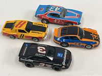 Group shot of four slot cars from top view