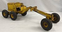 Full view of yellow Doepke Adams Motor Grader toy with six tires