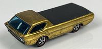 Left rear-quarter view showing gold finish, blue windshield, redline wheels