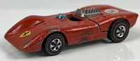 Side view of red Hot Wheels Ferrari 312P showing overall wear, wheels, Ferrari decal